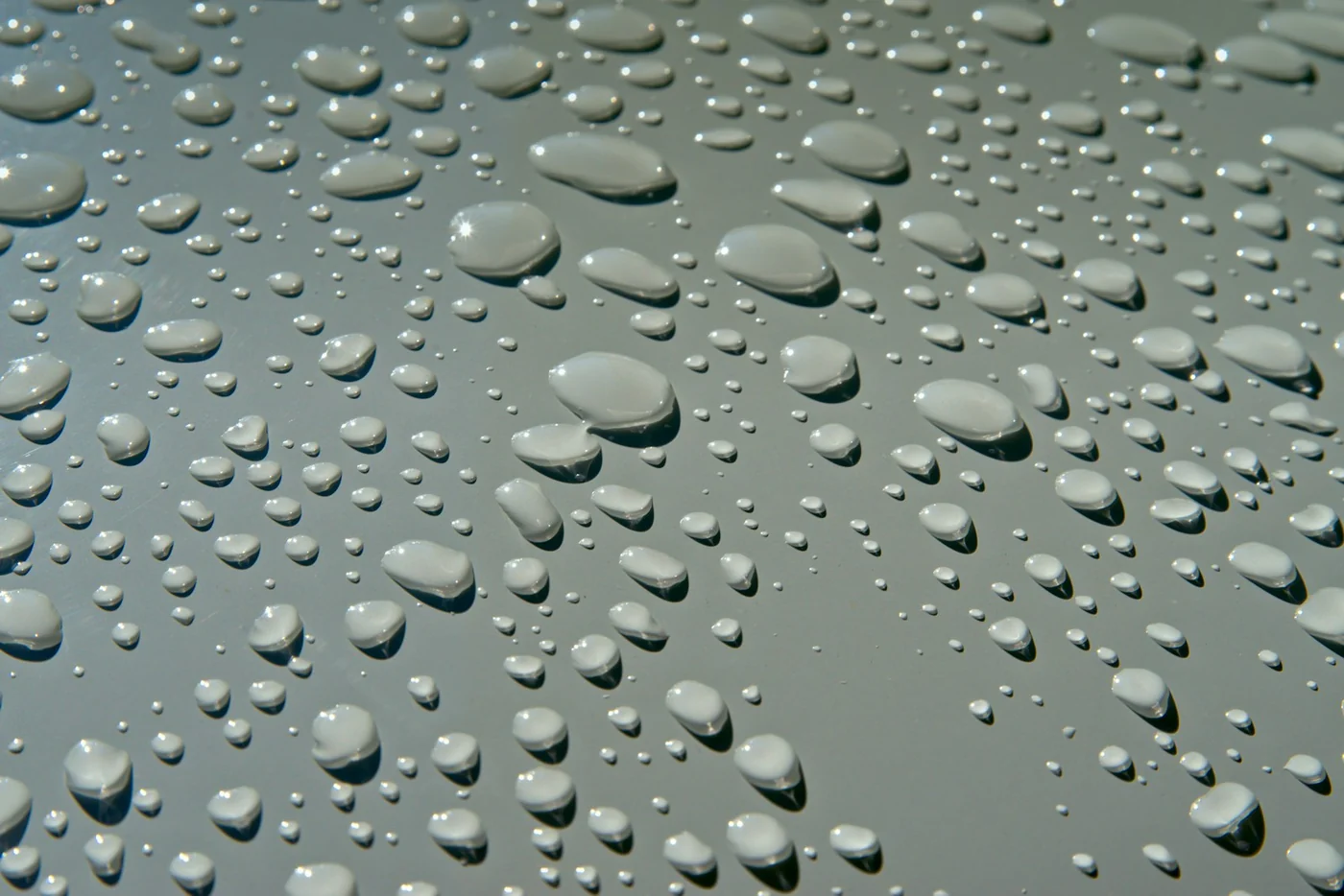 Water droplets on a metal/stainless surface — easy-clean effect