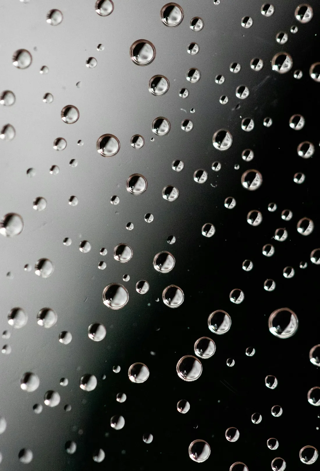 Water droplets beading and sliding off a protected surface